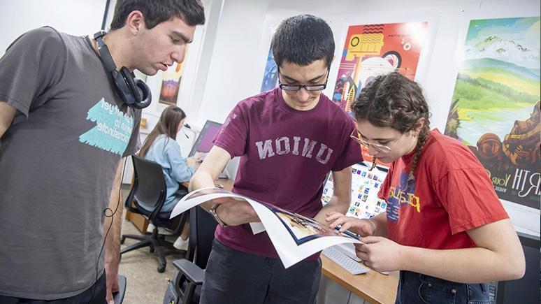 Students studying an artistic print